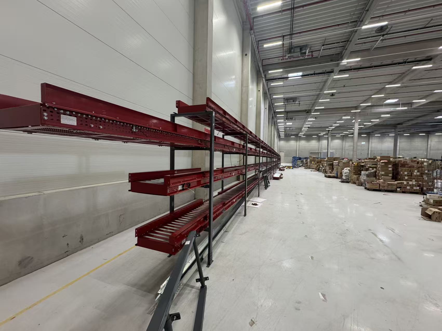 Conveyor automation at a logistics facility